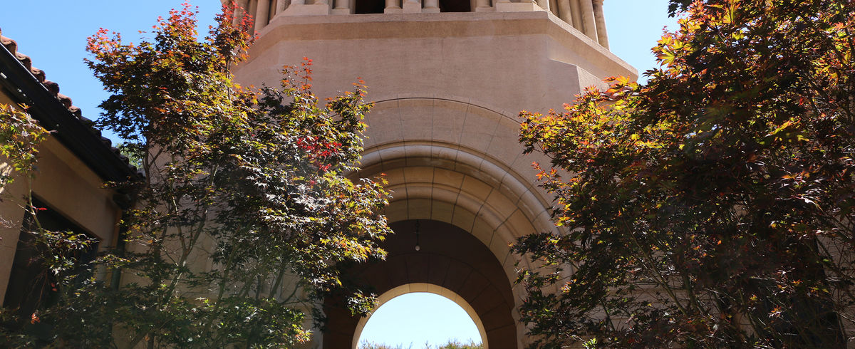 Encina commons arch with foliage.